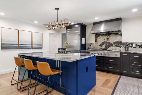 Modern kitchen with a spacious island and chic barstools, ideal for casual dining or entertaining.