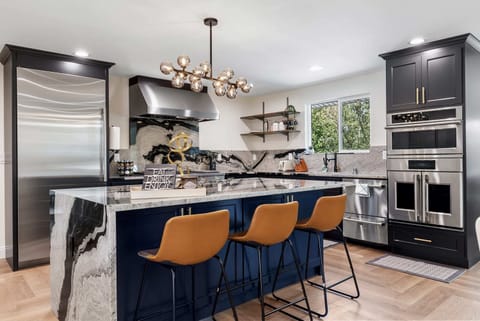 Sleek, contemporary kitchen with state-of-the-art appliances and ample counter space for cooking enthusiasts.