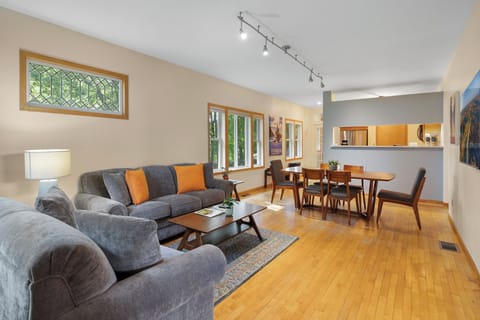 Relax in your spacious open-plan living area with plush sectional seating and warm wood floors that flow into the dining space.