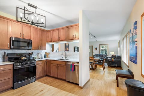 Your fully-equipped kitchen flows seamlessly into the living area, perfect for preparing meals while staying connected with your travel companions.