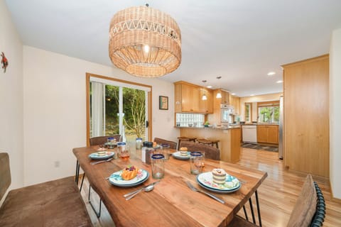 Dining room open to the gourmet kitchen with access to back deck with BBQ, outdoor dining table.
