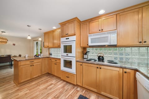 Gourmet kitchen with double oven breakfast bar and open to the dining room.