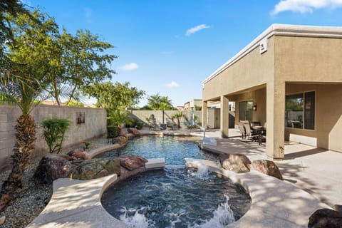 Hot tub and pool with waterfall feature