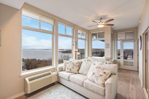 The back sunroom features a queen sleeper sofa, table, & stunning views