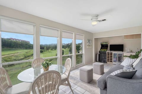 Enclosed Sun Room with ample seating, futon, dining table, and view