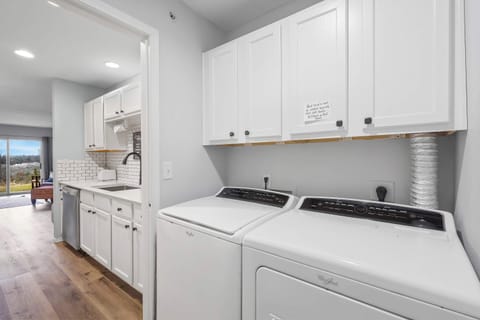 Private laundry is available for your stay, tucked away off the kitchen