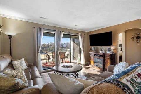 Modern spacious living area with TV and fireplace