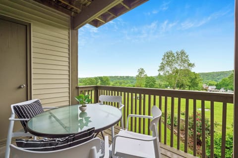 Balcony with outdoor seating and golf course view