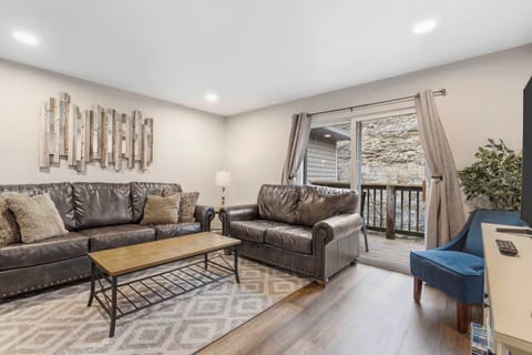 Open living space with TV, and balcony access (Unit #3)