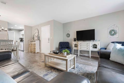 Open living space with TV, Full size sofa sleeper, and balcony access