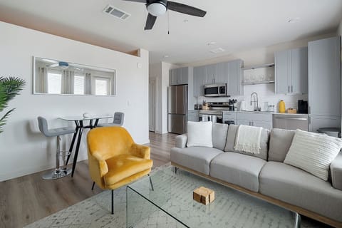 Open concept living room with lots of natural daylight with large smart TV