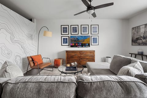 Large living room space with comfy sectional and smart TV