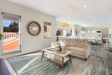 Bright, open living space with modern seating, natural light, and seamless flow to the outdoor terrace—perfect for relaxing or entertaining.