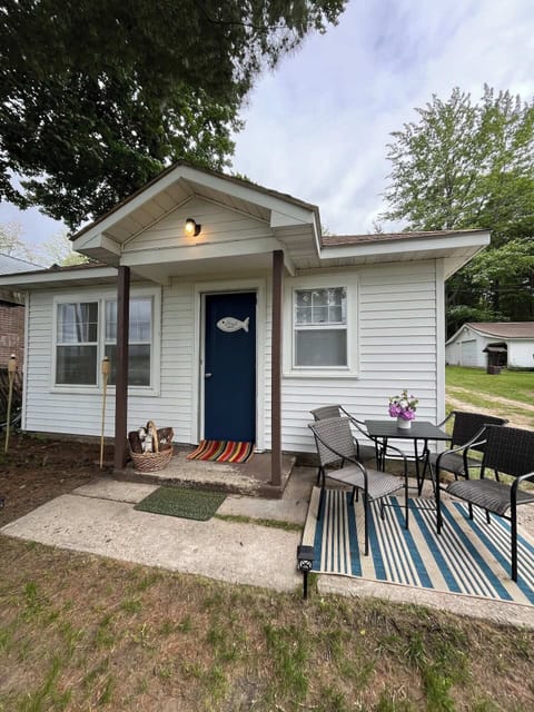 OVERALL: The front of the cabin and the outdoor dining furniture