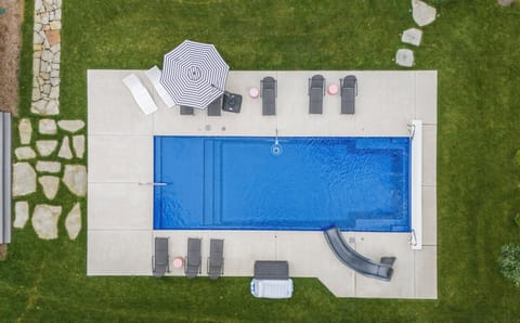 Aerial view showcasing the home's spacious backyard pool oasis.