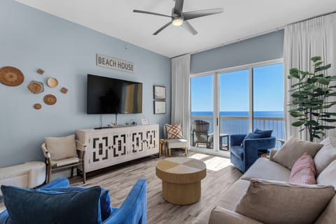 Living Room - Experience luxury and comfort in this beachfront retreat with a large flat-screen TV, chic decor, and stunning views of the ocean right from your couch.