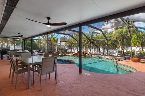 Outdoor dining table offering poolside views for shaded group meals.