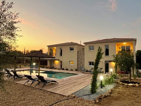 Le Clos de l'Oliveraie pool area at sunset