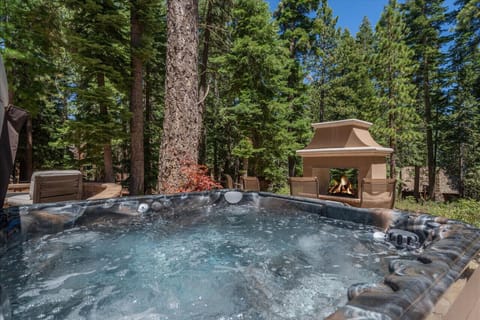 Hot Tub Oasis: Unwind in a serene hot tub surrounded by towering pines and warm outdoor fireplace!