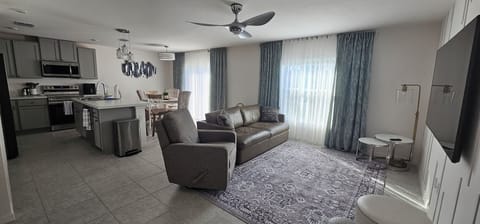 living room with long leather coach and recliner chair 
