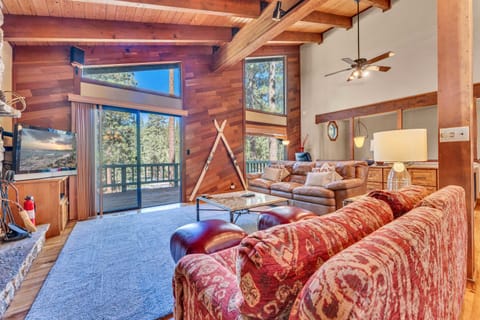 Living Room: Leather couch, 2 club chairs, dedicated workspace, 46” TV, wood-burning fireplace, patio access