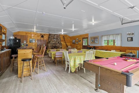 The Rec Center - A spacious rec room offering ample dining space, cozy seating, and a bar area for group meals and entertainment.