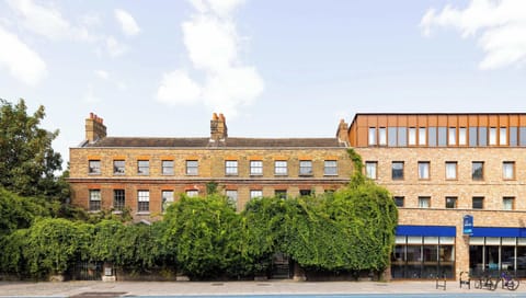 Malplaquet House charming brick facade surrounded by lush greenery