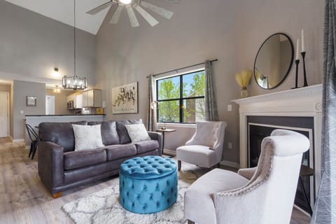 Open living space with sofa sleeper, Smart TV, and electric fireplace