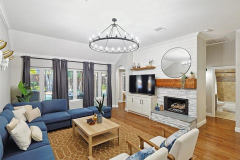 Featuring a beautiful blue sectional, a TV, a fireplace, and rustic furnishings, this living room offers you a balanced environment in which you can feel at home. 