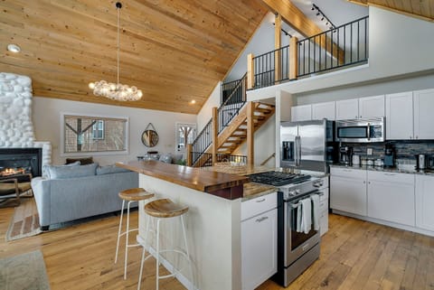 Kitchen offers stainless steel appliances, gas range, and deck access.