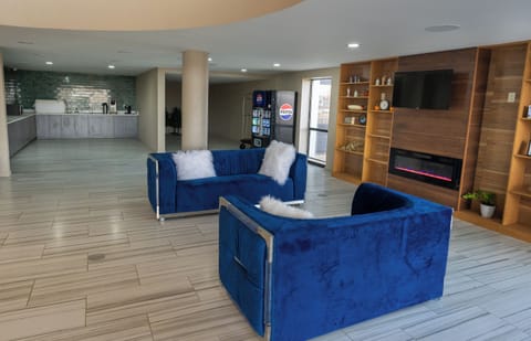 Room, 2 Queen Beds | Living area | 50-inch LED TV with cable channels