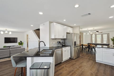 Fully equipped for all your cooking needs, this kitchen is sure to delight any home chef with its stainless steel appliances, breakfast bar, and ample counter space!