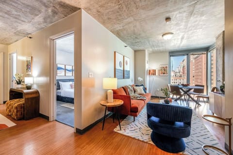 Bright, stylish apartment with a cozy living area, city views, and a peaceful bedroom retreat