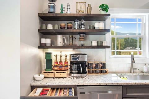 Our luxury house offers premium coffee makers, including French Press, Nespresso, and drip, with perfectly stocked supplies and modern appliances on open shelving. Whether you crave a quick espresso or a rich, slow brew, we’ve got your perfect cup covered.