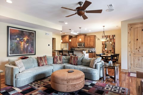 - Gather in the open living room with plush sectional  
- Connect with friends in a space made for comfort  
- Open layout with direct flow into kitchen and dining