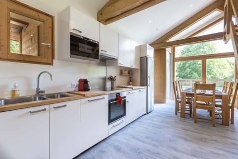 Prepare meals in this fully equipped kitchen that boasts modern appliances and sleek design. The large windows provide plenty of natural light and offer stunning views while you cook.