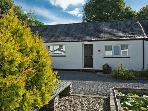 Front of cottage leading to gravel area and fish pond