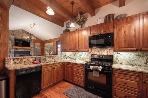 - Fully equipped kitchen with granite counters and stove - Ample cabinets, dishwasher and microwave for guests - Cook favorite recipes in this inviting wood-style space