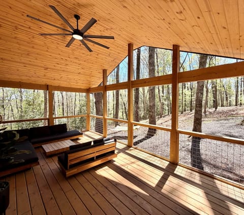 Covered porch with forrest views and a deer feeder