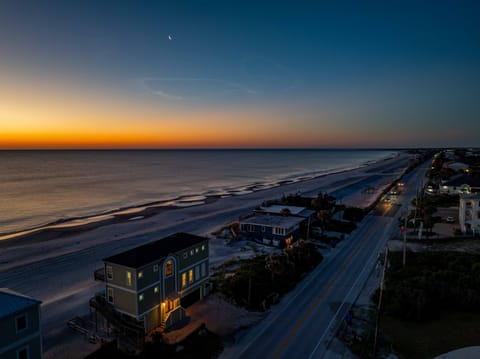 Experience a breathtaking beachfront sunset where vibrant colors meet the calm shoreline creating the perfect backdrop for peaceful evenings by the ocean.