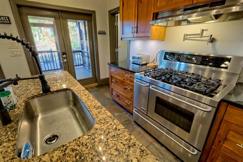 Large gas stove and direct access to the outdoor deck.