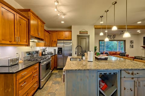 Cook together in the open-concept kitchen with stainless appliances, granite counters, and plenty of space.