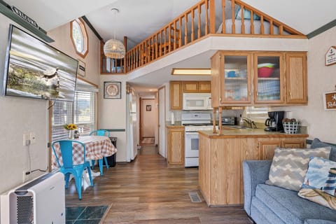 Functional kitchen featuring a small breakfast table for two, ideal for quick meals or morning coffee.