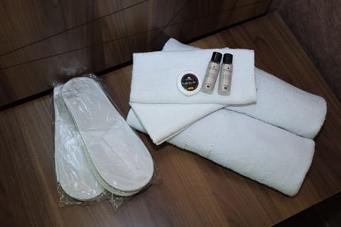 Shower, hair dryer, slippers, towels