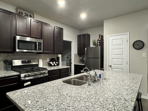 Open kitchen with gas appliances! Fully stocked for cooking needs.