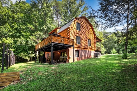 This stunning log cabin is set against lush, green scenery—your private retreat in nature.