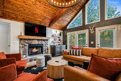 This stunning retreat features a gorgeous wood and bean ceiling, coxy gas fireplace, a luxurious leather section and spacious dining area with seating for 12. 