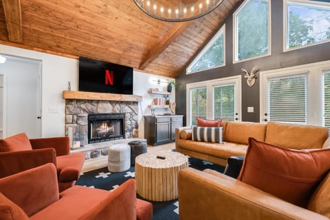 This stunning retreat features a gorgeous wood and bean ceiling, coxy gas fireplace, a luxurious leather section and spacious dining area with seating for 12. 