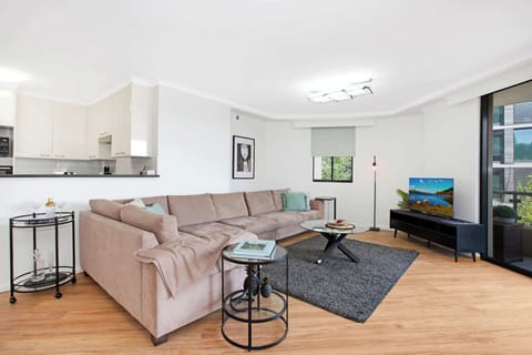 Living room with large comfy lounge and TV