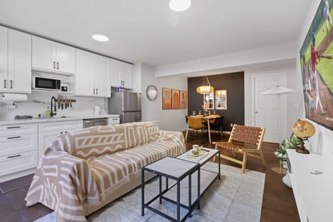 Bright and cozy living room with modern decor, perfect for relaxing after a day of exploring the city.